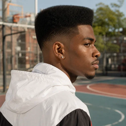 Flat top fade haircut with a clean squared top and precise tapered side