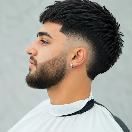 Young man with a mid burst fade haircut