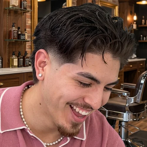 Close-up side view of a modern mullet haircut with a burst fade
